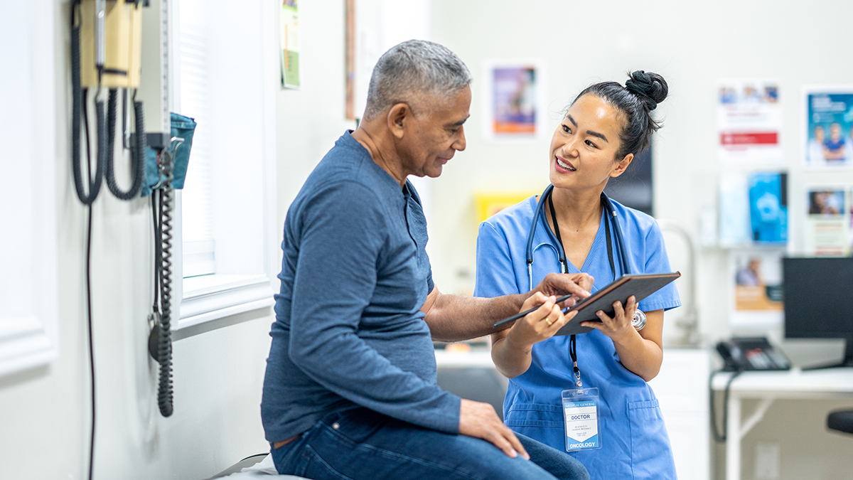 Medical professional shaking hands with a man.