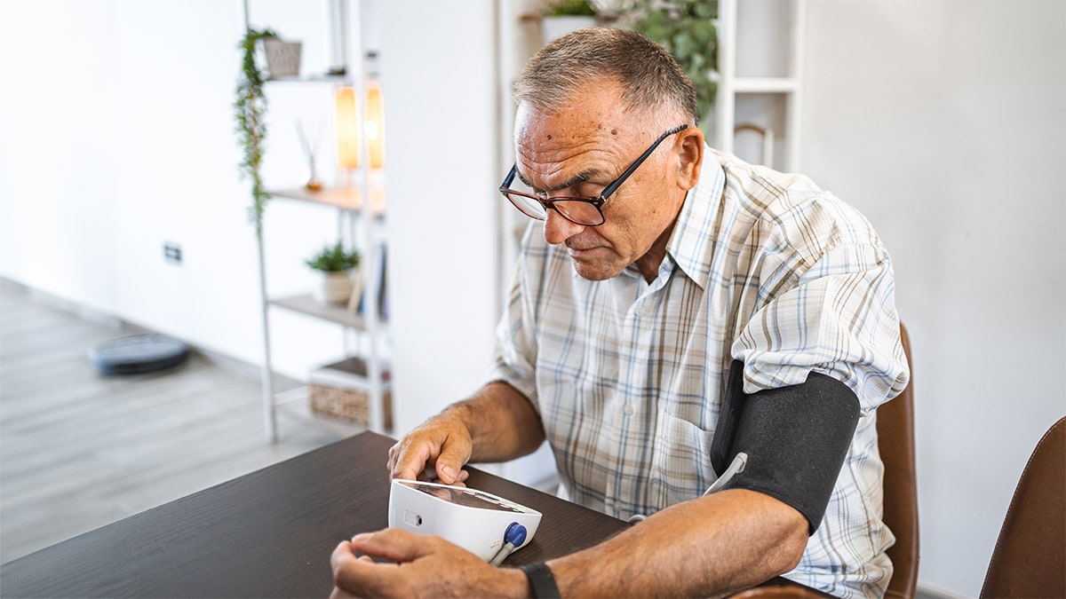 Older man self-monitors blood pressure