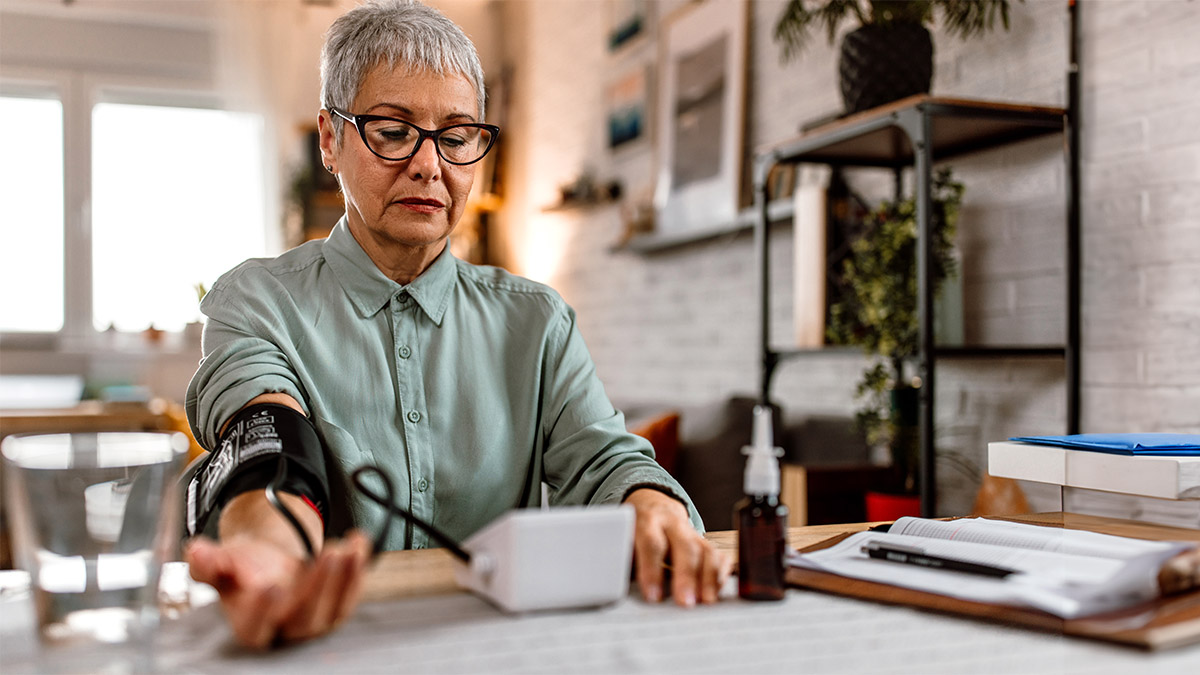 Older woman self-monitoring blood presure