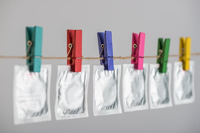 photo of a row of condoms hanging on a clothesline