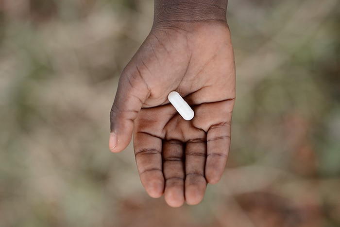 photo of a hand holding a pill