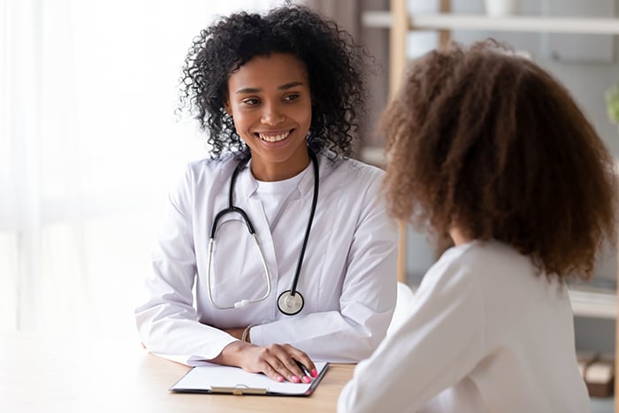 African-American doctor consulting with another African-American woman