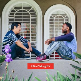 Two men smiling outside. Text says: #StartTalkingHIV.