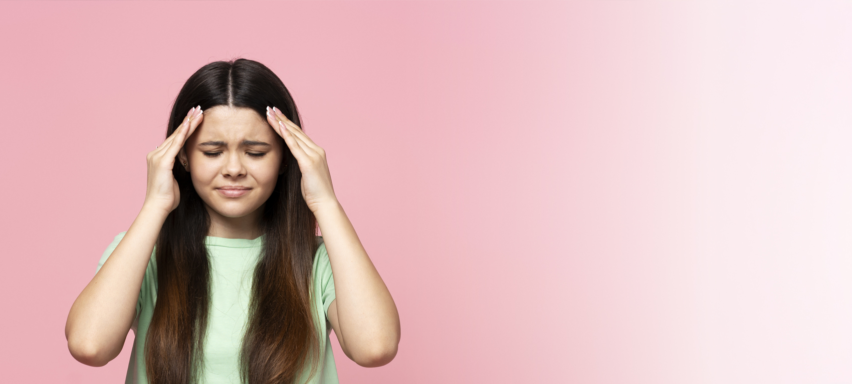 Young woman holding her head in pain