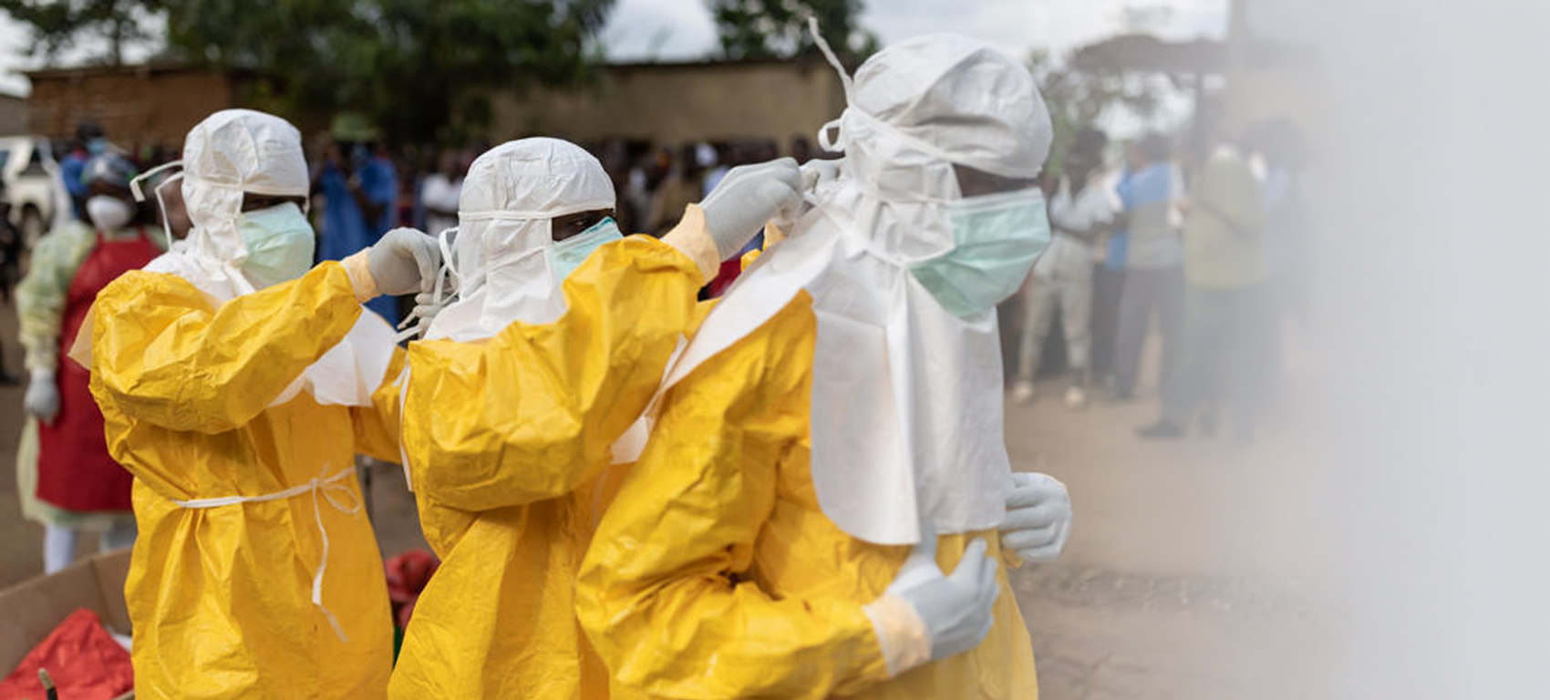 Three disease detectives wearing personal protective equipment