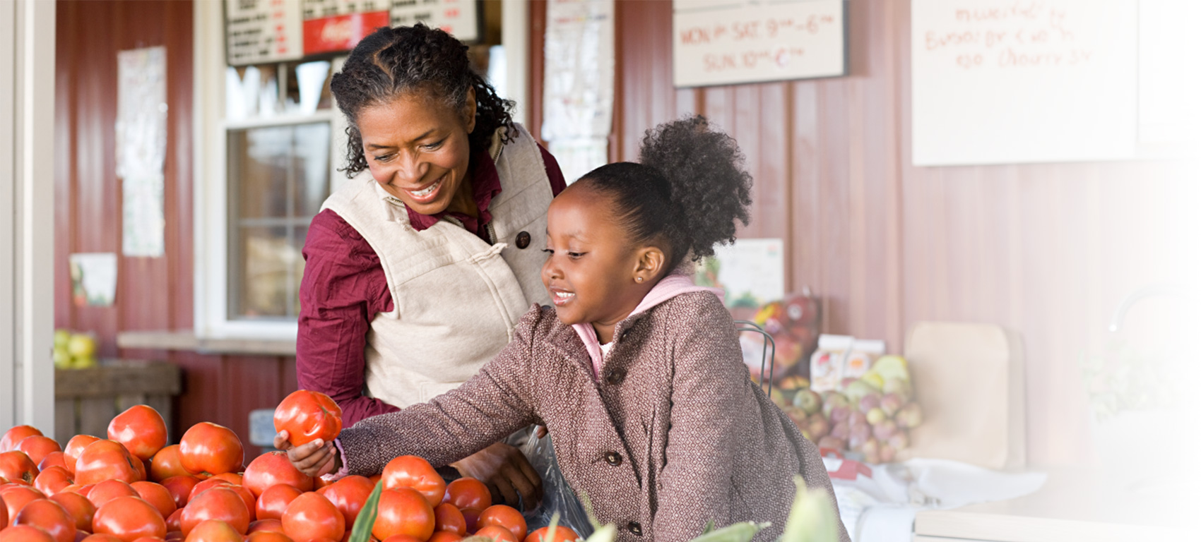 A mother and daughter looking at fresh vegetables