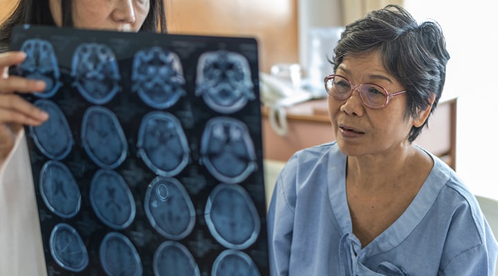 Older woman at doctor’s visit looking at a brain scan