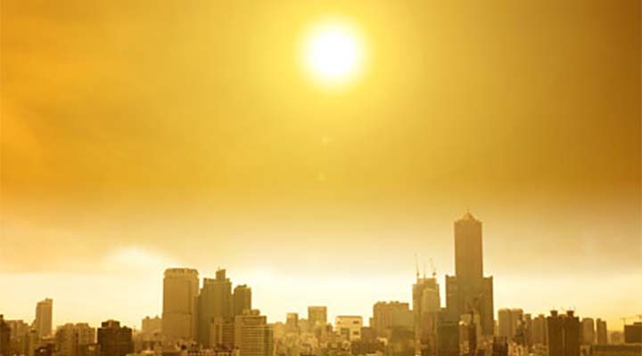 Bright sun shining over city
