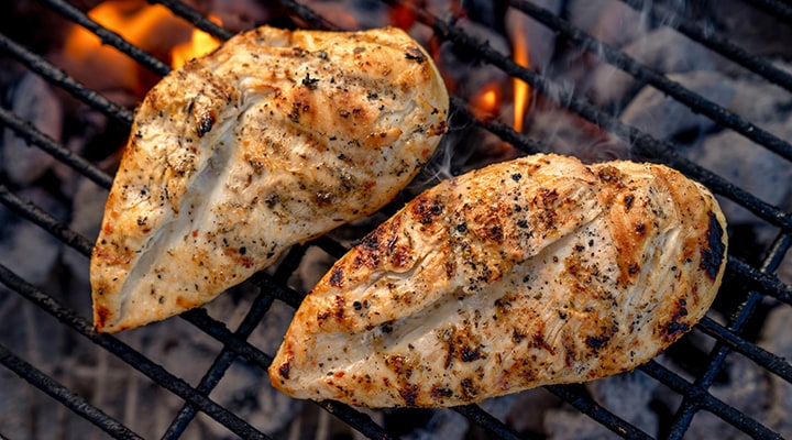 pieces of chicken on a grill