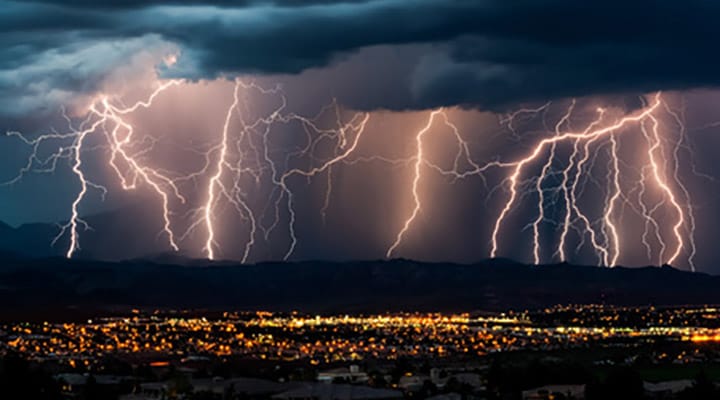 Severe lightning over a city at night