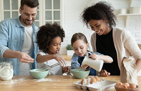 Diverse family making breakfast together