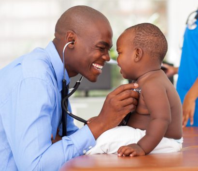 Male doctor examining baby boy