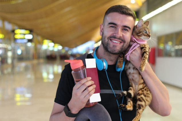 photo of a man holding a cat