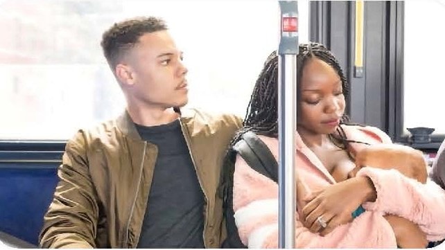 Parents comforting baby on a train.