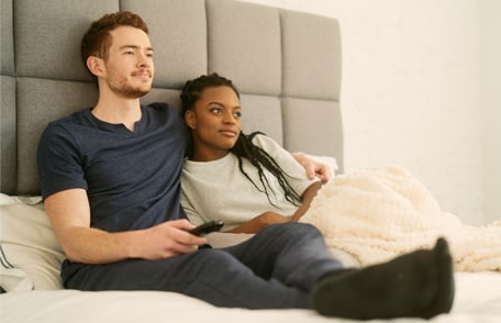Image of a young couple watching tv