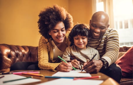 Image of a happy family coloring a picture