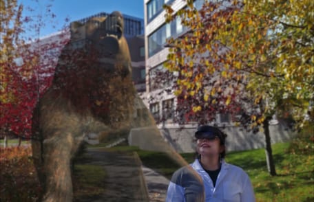 A user taking a holographic bear for a walk across the Anchorage health campus
