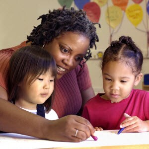 Childcare center: A teacher with two children