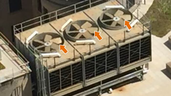 A cooling tower with fan blades visible.