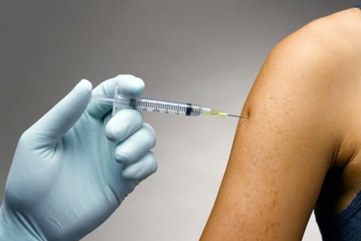 Person receiving a vaccine in the arm