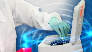 Laboratory staff member using a centrifuge