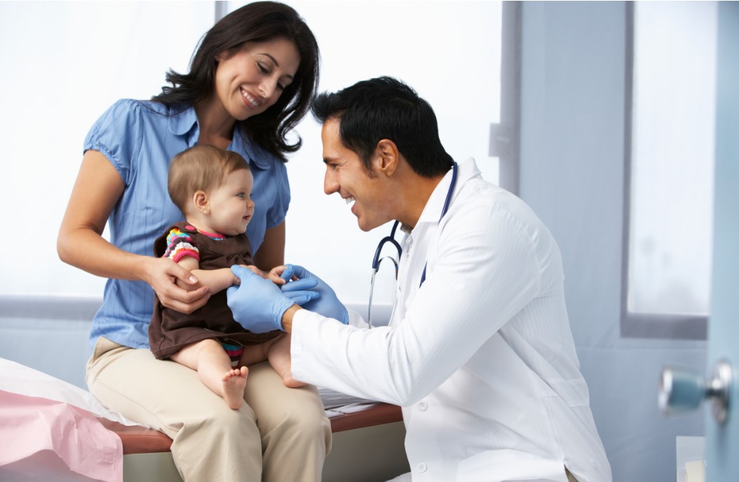 Doctor Examining Baby Girl with Mother