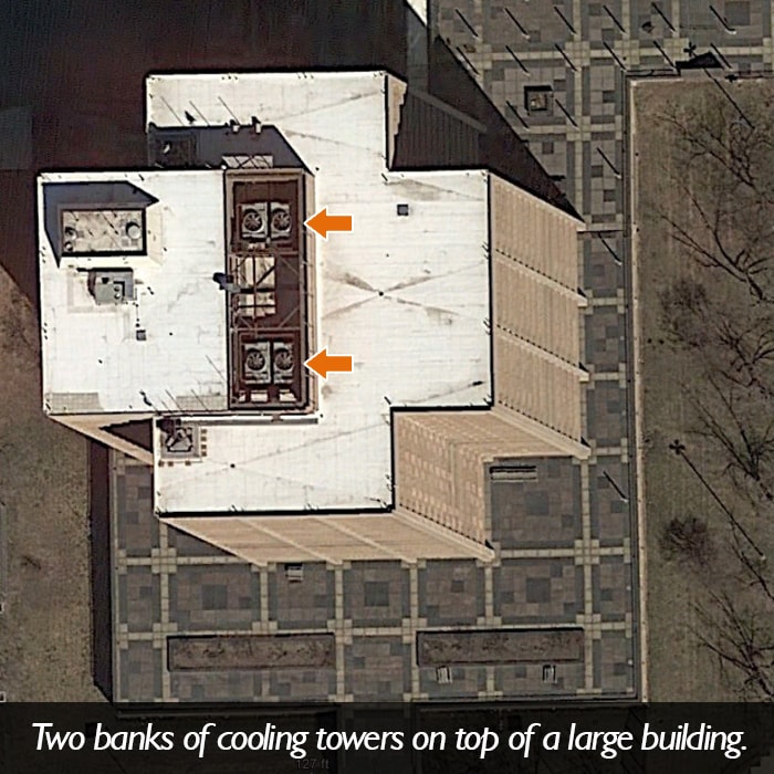 An aerial picture of two banks of cooling towers on top of a large building.