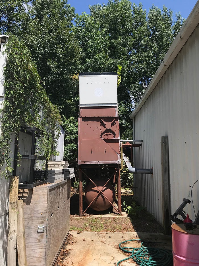 An elevated cooling tower with a side fan that is not visible.