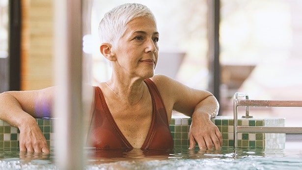 An older woman relaxing in a hot tub