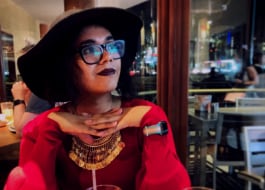A transgender person enjoying ambiance of a restaurant setting
