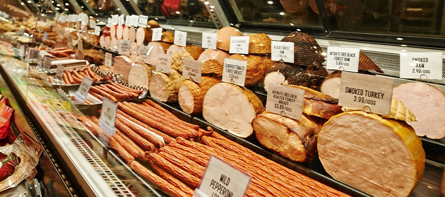 Shop with deli meat and cheese on shelves