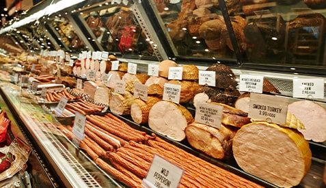 Store with deli meat and cheese on shelves