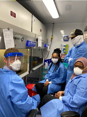 LLS fellow Stephen LaVoie (Class of 2020), far left, trains staff in a U.S. Virgin Islands public health laboratory on COVID testing instruments.
