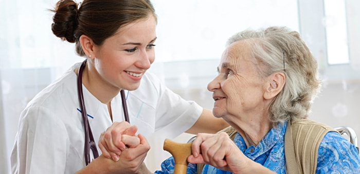 Doctor talking to elderly lady in nursing home