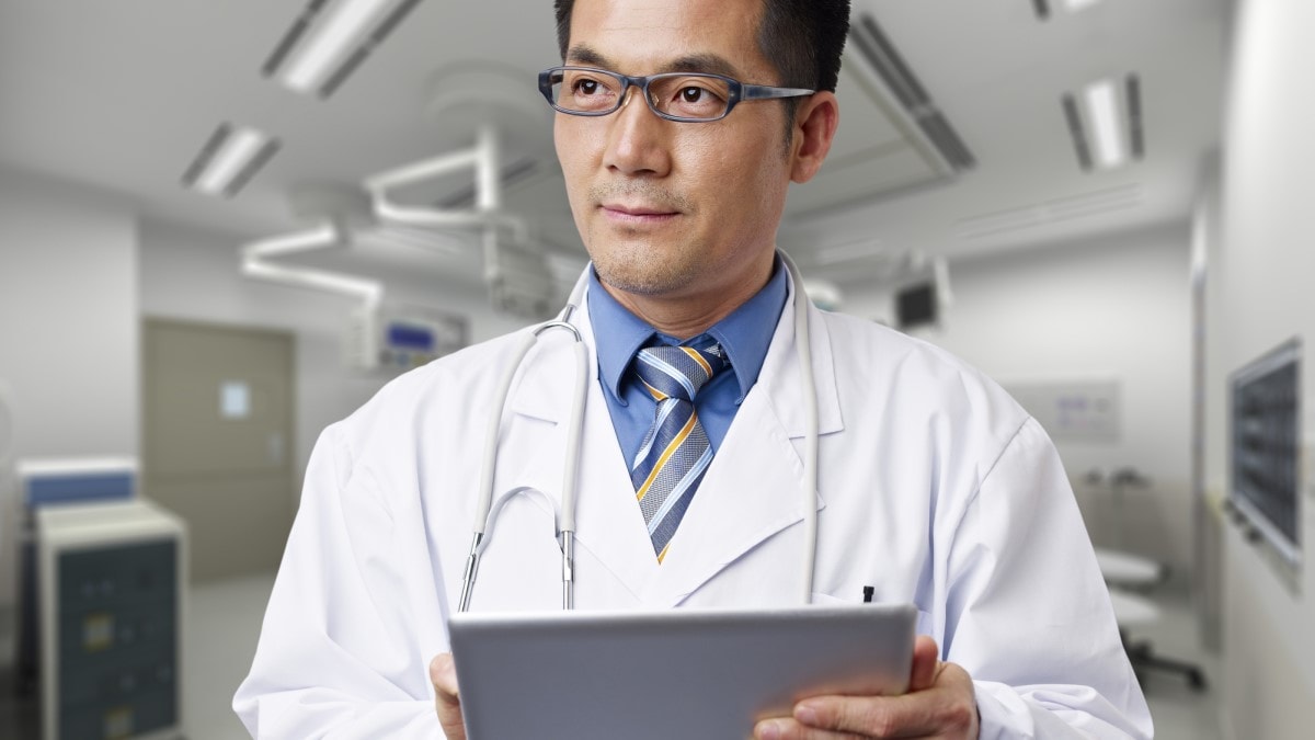 Photo of a doctor holding a digital tablet