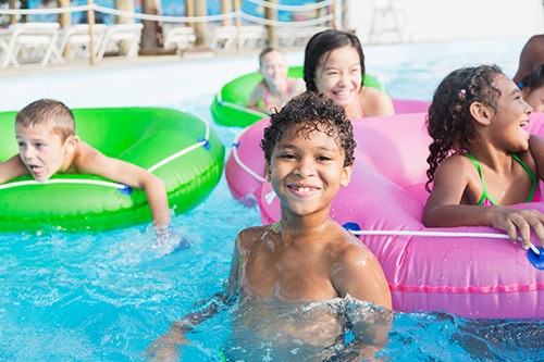 Boy with friends having fun at a water park