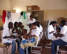 Health workers test children with fever for malaria in a busy clinic in Luanda, the capital of Angola.