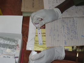 Health worker in Tanzania performing an RDT. (Courtesy S. Patrick Kachur)