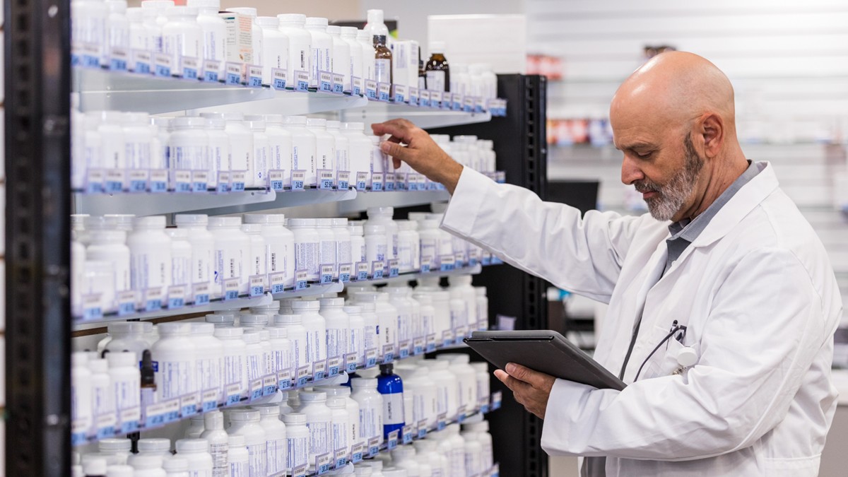 A hospital pharmacist fills a prescription.