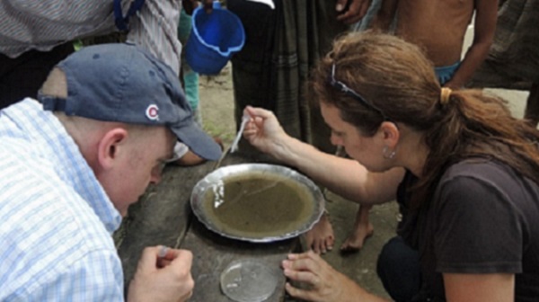 Scientist testing a sample of water for Anopheles mosquito larvae.