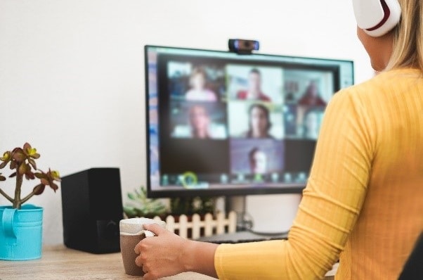 woman using computer for virtual meeting