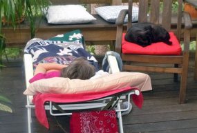 woman laying in recliner on back deck