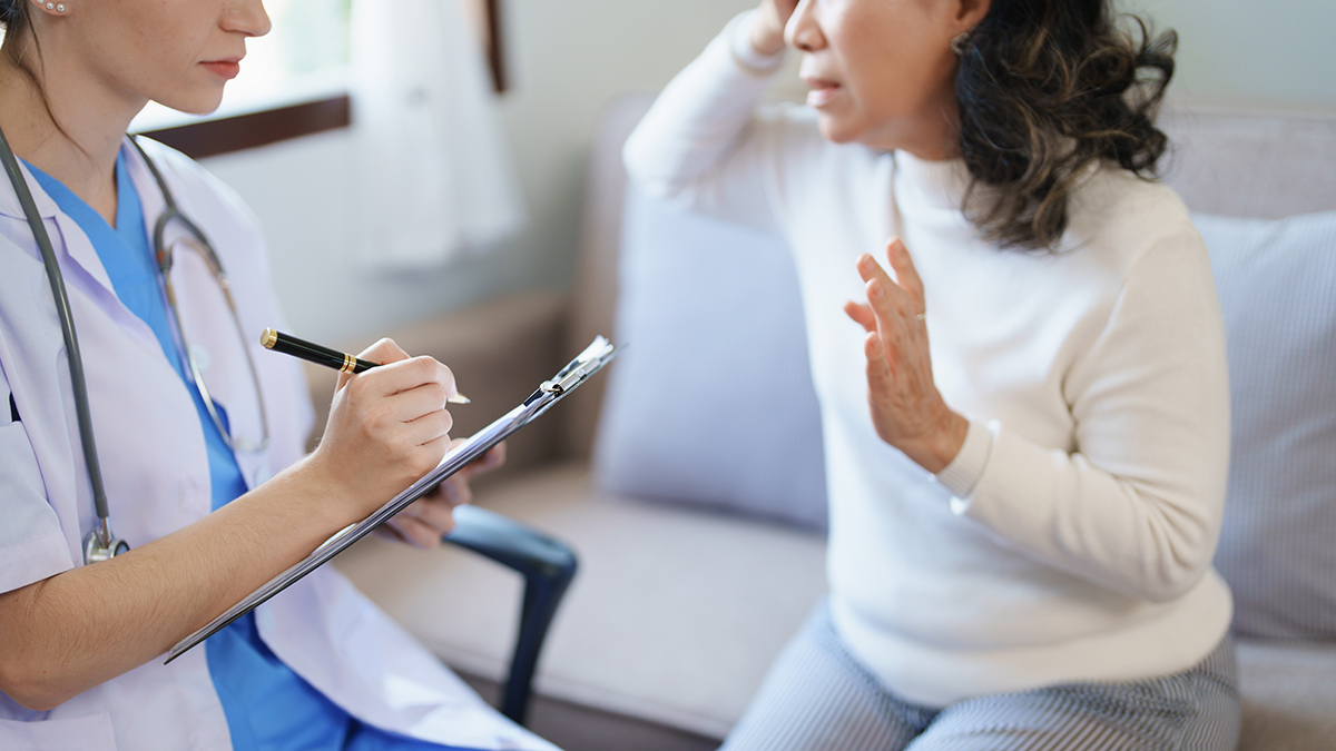 female doctor holding a patient clipboard to discuss and analyze the patient's condition before treating