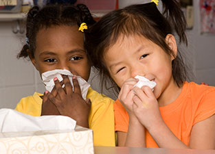 two girls holding tissues