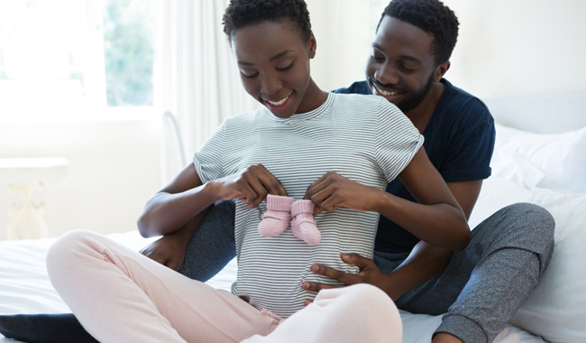 husband and wife with baby boots