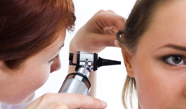doctor checking a woman's ear