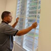  Man installs indoor window screens 