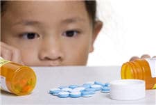 child looking at medicine on counter