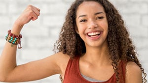 teen girl with her arm upraised