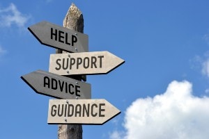 Sign post pointing to Help, Support, Advice, Guidance